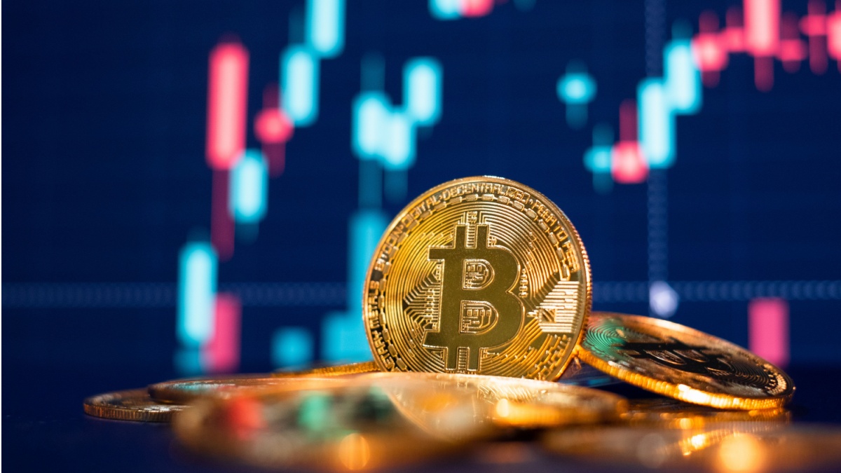 Bitcoin gold coin and defocused chart background.