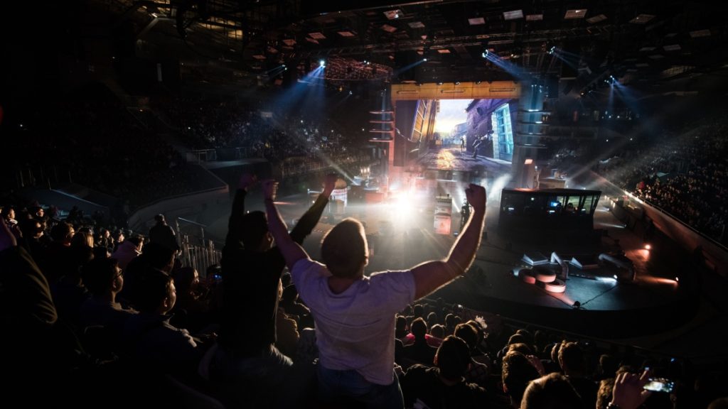 Counter Strike: Global Offensive cyber sport event. Main venue and fan of one of the teams in front.