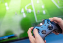 EFL inks deal with EA SPORTS FC to bolster global appeal Man playing video game using an XBOX controller.