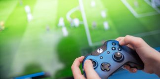 EFL inks deal with EA SPORTS FC to bolster global appeal Man playing video game using an XBOX controller.