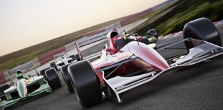 F1 Academy partners with American Express to ‘elevate’ women Red race car close up front view on a track leading the pack with motion.