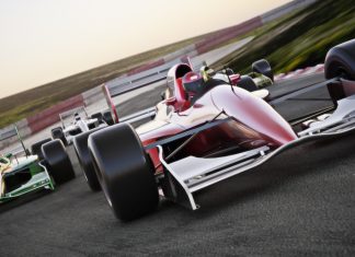F1 Academy partners with American Express to ‘elevate’ women Red race car close up front view on a track leading the pack with motion.