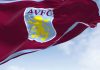 Aston Villa’s £20m Visit Rwanda deal draws sportswashing warning The flag of Aston Villa Football Club waving in the wind on a clear day.