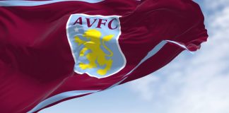 Aston Villa selects Adidas ahead of Champions League debut The flag of Aston Villa Football Club waving in the wind on a clear day.
