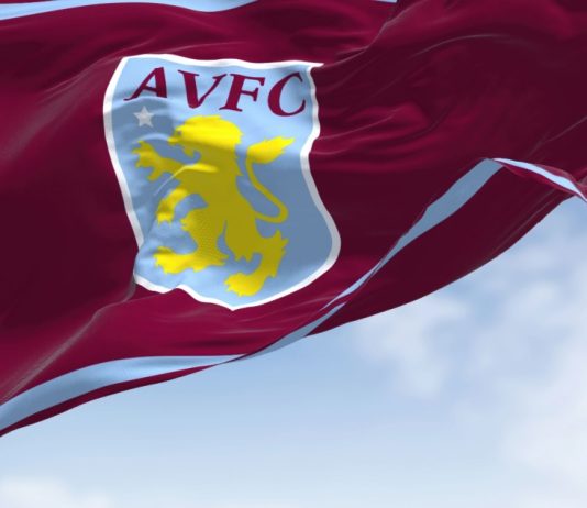 Aston Villa’s £20m Visit Rwanda deal draws sportswashing warning The flag of Aston Villa Football Club waving in the wind on a clear day.