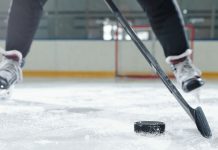 PokerStars moves to up US visibility with Philadelphia Flyers deal Legs of male hockey player in sports uniform and skates moving down rink in front of camera against stadium environment while going to shoot puck.
