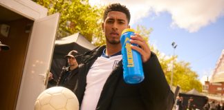 Jude Bellingham set to star in Lucozade TV campaign Jude Bellingham holding a football and a Lucozade branded bottle.