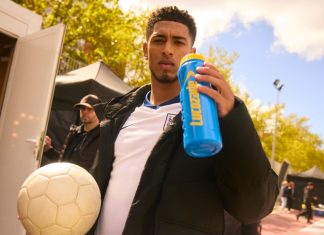 Jude Bellingham set to star in Lucozade TV campaign Jude Bellingham holding a football and a Lucozade branded bottle.