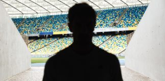 Matchday Programme: Matthew Wojciow – the ‘greatest Champions League comeback’ Silhouette of a man walking throught the stadium entrance.
