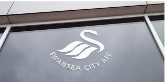FA amends Swansea City liaison’s ‘lenient’ betting suspension Swansea City logo on a window at Liberty Stadium in Swansea, Wales.