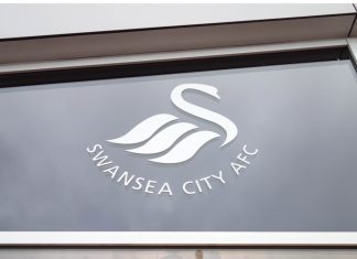 FA amends Swansea City liaison’s ‘lenient’ betting suspension Swansea City logo on a window at Liberty Stadium in Swansea, Wales.