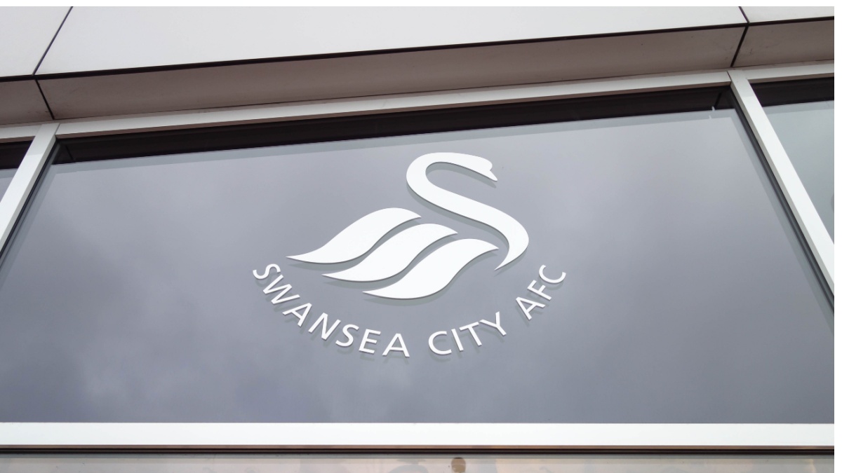 Swansea City logo on a window at Liberty Stadium in Swansea, Wales.