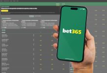 bet365 suffers ‘biggest payout’ of the season on the final day Man holding a smartphone iPhone 14 Pro with Bet365 betting provider app on the screen.