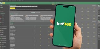 bet365 suffers ‘biggest payout’ of the season on the final day Man holding a smartphone iPhone 14 Pro with Bet365 betting provider app on the screen.
