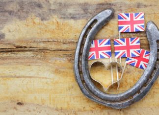 New chair appointed to oversee UK horse racing betting levy Old rustic horseshoe hanging on door said to bring good fortune and luck according to superstition.
