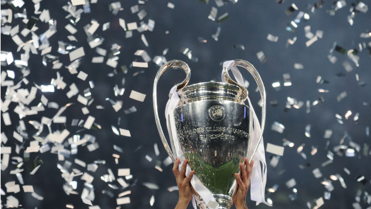 Champions League cup in the hands of the winner, confetti on the background. UEFA Champions League final between Real Madrid and Liverpool. NSC Olympic stadium in Kyiv.