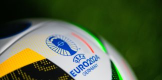 Ladbrokes joins the Euro 2024 marketing wave with latest campaign Logo of Euro 2024 in Germany. Detail at Official Adidas soccer ball Fussballliebe for Euro 2024 placed on green grass.