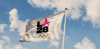 Will LA28’s venue naming rights tip the Olympics into over-commercialisation? A photo illustration of the LA28 Summer Olympic Games logo on a flag.
