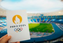 Kuaishou set to boost Chinese engagement for Paris Olympics Icon of Summer olympic Games Paris 2024 Held by Athlete. Modern Stadium in background. Wallpaper for Summer Olympic Game in Paris 2024.