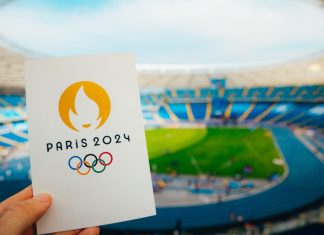 Kuaishou set to boost Chinese engagement for Paris Olympics Icon of Summer olympic Games Paris 2024 Held by Athlete. Modern Stadium in background. Wallpaper for Summer Olympic Game in Paris 2024.