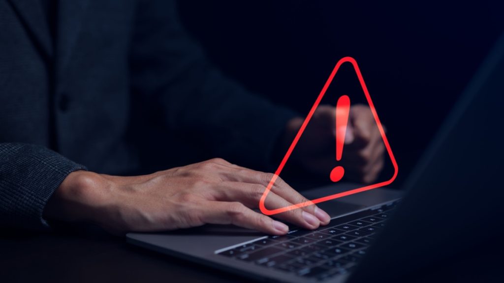 Businessman working on the computer. Warning alert system concept, hacked on the computer network, crime and virus, Malicious software, compromised information, illegal connection, data vulnerability.