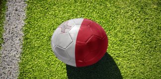 Malta FA Trophy gains Meridianbet as title sponsor Football ball with the national flag of Malta on the green field near the white line.
