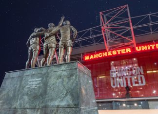 Manchester United extends Konami deal with eFootball rewards Manchester United , Old Trafford Stadium. United Trinity Statue, George Best, Denis Law and Bobby Charlton reaching for the Stars.