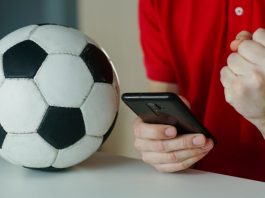 iGaming Daily: Bridging the gap between fantasy football and gambling Man celebrates football win on his phone