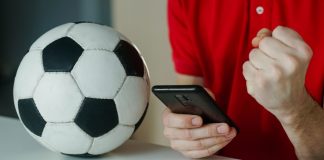 iGaming Daily: Bridging the gap between fantasy football and gambling Man celebrates football win on his phone