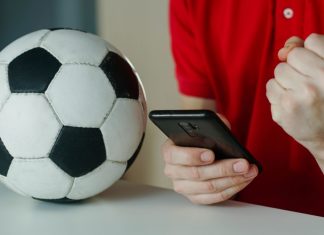 iGaming Daily: Bridging the gap between fantasy football and gambling Man celebrates football win on his phone