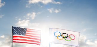 Orlando eyes up Florida Olympics amid US sporting boom The iconic Olympic flag waves proudly beside the American flag under a vibrant sky.