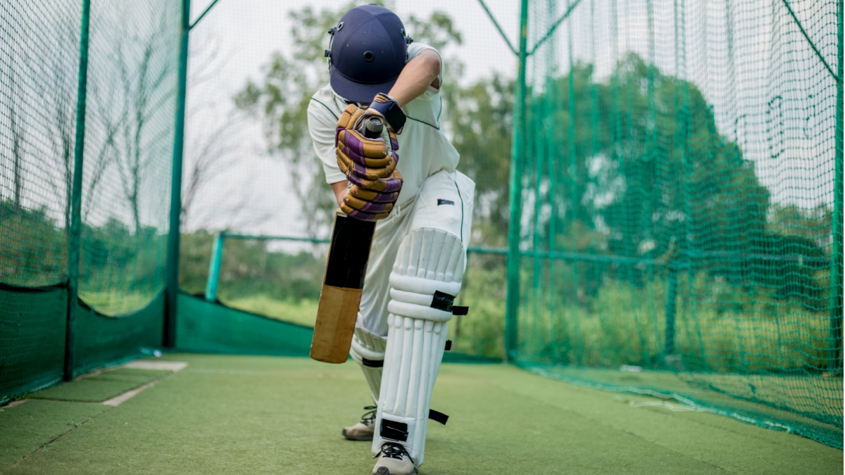 Front view of Cricket Batsman Action, Cricket game closeup player batting ball.