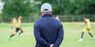 Emma Hayes supports McDonald’s bursaries for football coaches Football or socker coach observing kid football match.