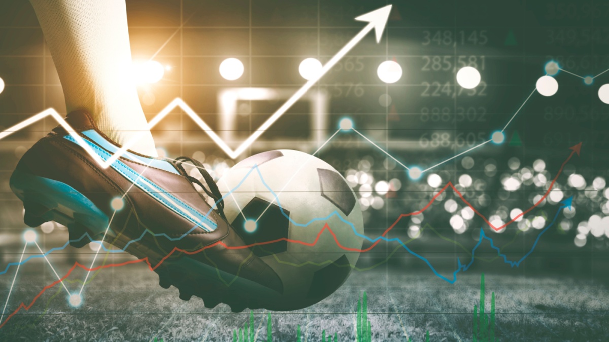Double exposure of soccer player feet kicking a ball in the stadium with upward arrow background.