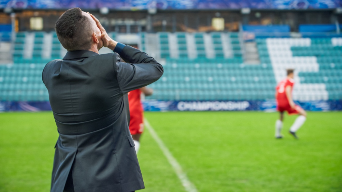 Professional Soccer Football Match Championship on Stadium with Disappointed Coach Training Players. Teams Attacks, Plays in Pass. Major League Cup World Tournament Concept. Back View.