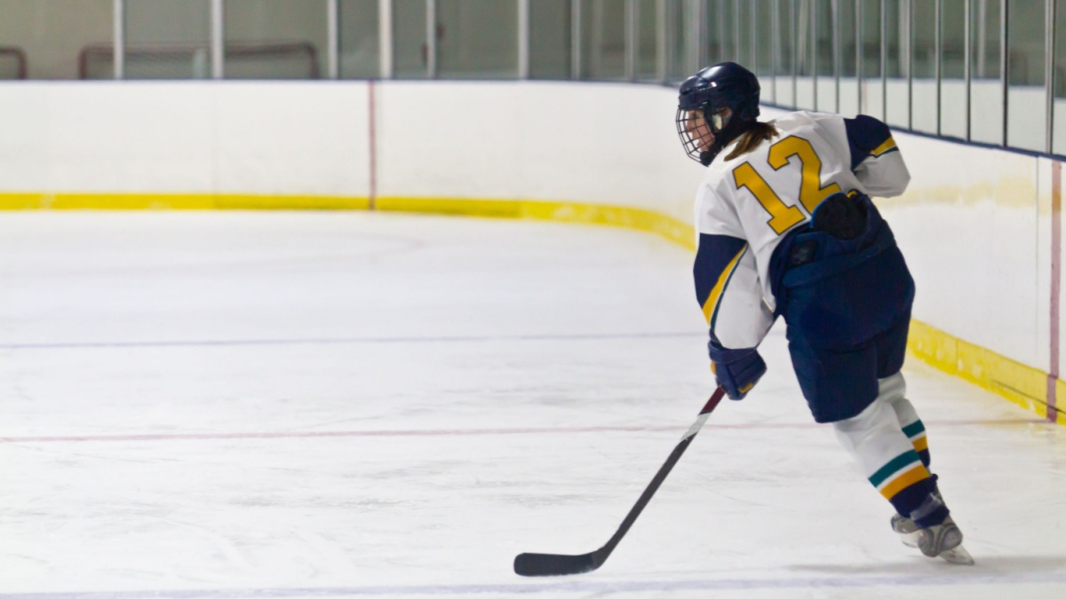 Female Ice hockey player during a game in an arena.
