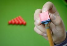 WST prepares for Masters event with OlyBet partnership Snooker player preparing for game.