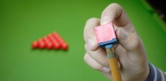 WST prepares for Masters event with OlyBet partnership Snooker player preparing for game.