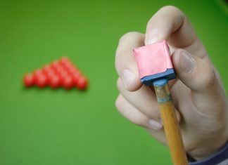 WST prepares for Masters event with OlyBet partnership Snooker player preparing for game.