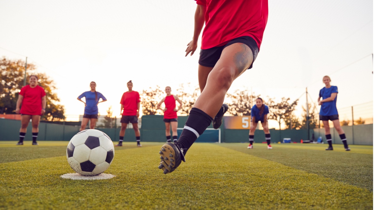Close Up Of Player Taking Penalty During Womens Soccer Match.