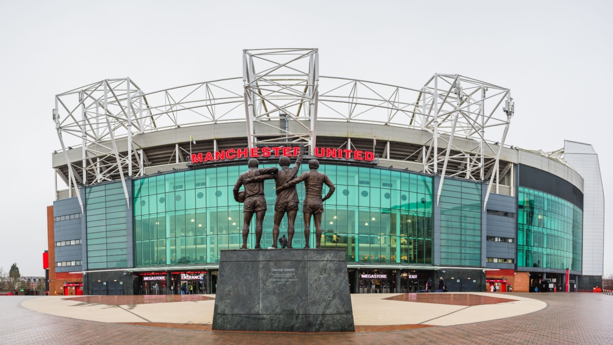 A multi image panorama of the United Trinity statue featuring Manchester United legends George Best, Denis Law and Sir Bobby Charlton pictured at Old Trafford stadium in Manchester on 2 January 2024.