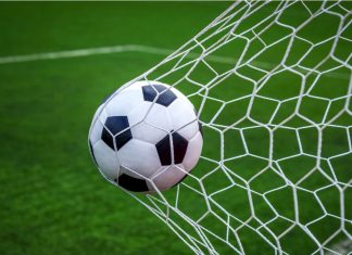 Barcelona S.C. scores big with 1xBet sponsorship Football on goal with net background, football player shoot a leather foot ball for make a score, Peru.