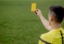 Kike Salas arrested over alleged sports betting scandal Referee showing a red card to a displeased football or soccer player while gaming. Concept of sport, rules violation, controversial issues, obstacles overcoming.