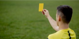 Kike Salas arrested over alleged sports betting scandal Referee showing a red card to a displeased football or soccer player while gaming. Concept of sport, rules violation, controversial issues, obstacles overcoming.