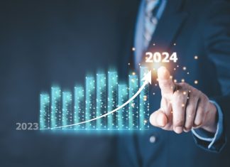 Better Collective overcomes ‘unforeseen challenges’ for strong 2024 results Column chart with company progress and growth by year, 2024, businessman calculates financial data for long term investments.