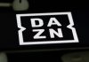 DAZN ruling shields Pro League from Ligue 1 situation Rheinbach, Germany 5 June 2021, The logo of the streaming service "DAZN" on the screen of a smartphone with white headphones and a remote control.
