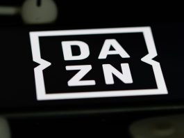 DAZN ruling shields Pro League from Ligue 1 situation Rheinbach, Germany 5 June 2021, The logo of the streaming service "DAZN" on the screen of a smartphone with white headphones and a remote control.