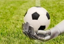 Football Media launches AI agent to enhance sponsorships A robot arm reaches out to a football. Soccer playing with machine. The robot arm is in front of a soccer grass field.