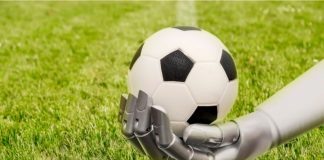 Football Media launches AI agent to enhance sponsorships A robot arm reaches out to a football. Soccer playing with machine. The robot arm is in front of a soccer grass field.