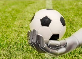 Football Media launches AI agent to enhance sponsorships A robot arm reaches out to a football. Soccer playing with machine. The robot arm is in front of a soccer grass field.